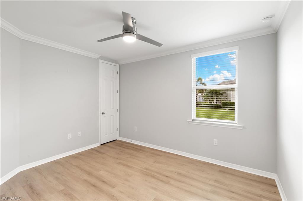 14618 Edgewater Circle Naples, FL 34114 - Photo 23 of 47 a view of an empty room with wooden floor and a window