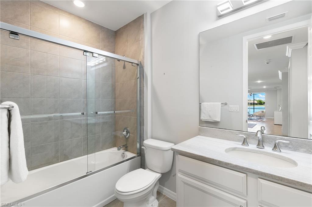 14618 Edgewater Circle Naples, FL 34114 - Photo 25 of 47 a bathroom with a sink a toilet and shower