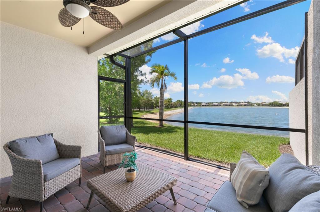 14618 Edgewater Circle Naples, FL 34114 - Photo 27 of 47 a living room with furniture and a floor to ceiling window