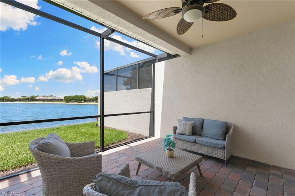 14618 Edgewater Circle Naples, FL 34114 - Photo 28 of 47 a living room with furniture and a floor to ceiling window