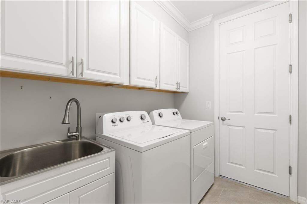 14618 Edgewater Circle Naples, FL 34114 - Photo 29 of 47 a utility room with dryer and washer