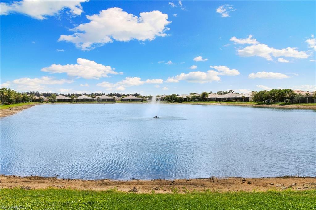 14618 Edgewater Circle Naples, FL 34114 - Photo 30 of 47 a view of a lake with houses in the back
