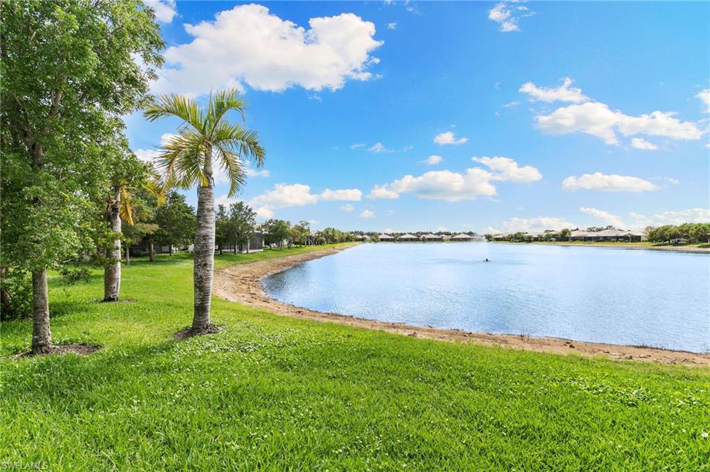 14618 Edgewater Circle Naples, FL 34114 - Photo 31 of 47 a view of a lake from a yard