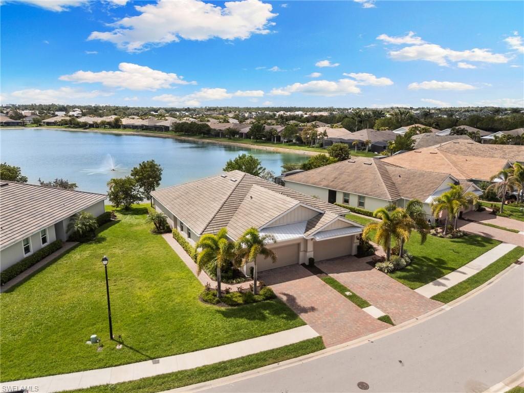 14618 Edgewater Circle Naples, FL 34114 - Photo 34 of 47 a view of a lake with a yard