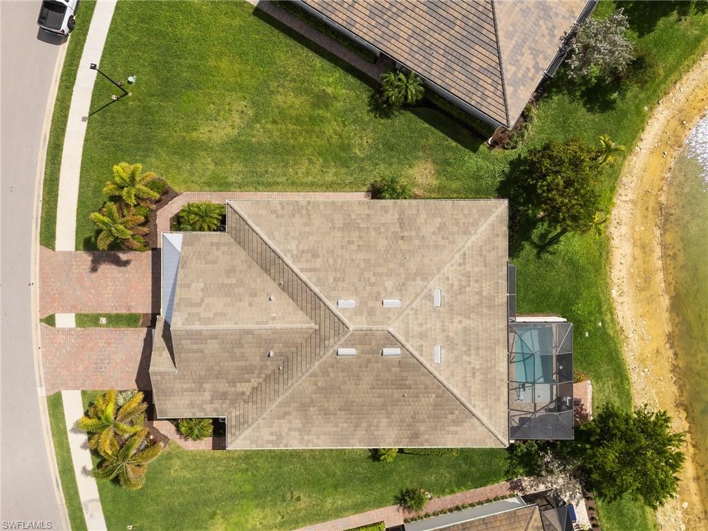 14618 Edgewater Circle Naples, FL 34114 - Photo 35 of 47 an aerial view of a house with a garden and swimming pool