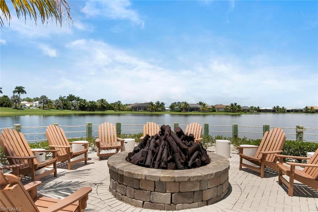 14618 Edgewater Circle Naples, FL 34114 - Photo 45 of 47 a view of a lake with couches chairs and a lake view