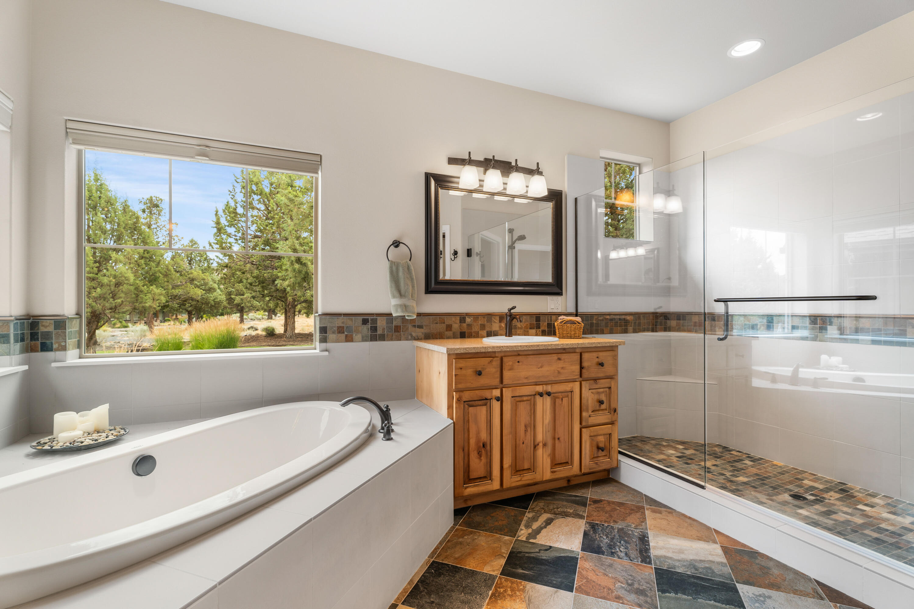 205 Vista Rim Drive Redmond, OR 97756 - Photo 25 of 85 a spacious bathroom with a tub sink and mirror