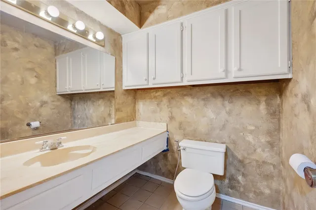 a bathroom with a sink a toilet and mirror