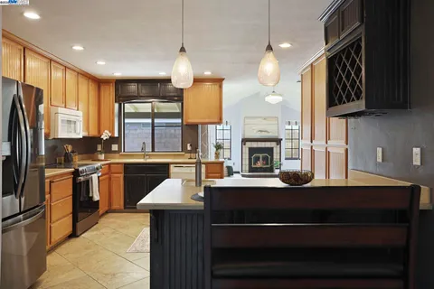 a kitchen with a refrigerator a stove top oven a sink and dishwasher