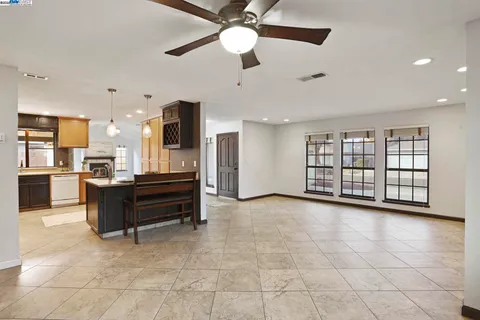 a view of kitchen with windows and ceiling fan