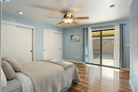 a bedroom with a large bed and a chandelier