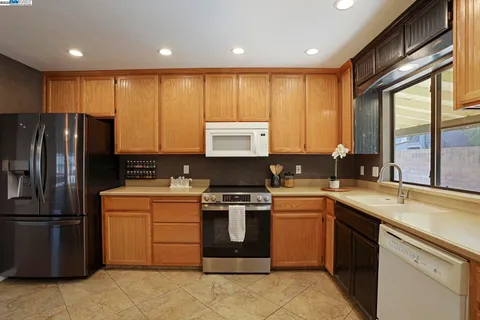 a kitchen with a stove sink and refrigerator