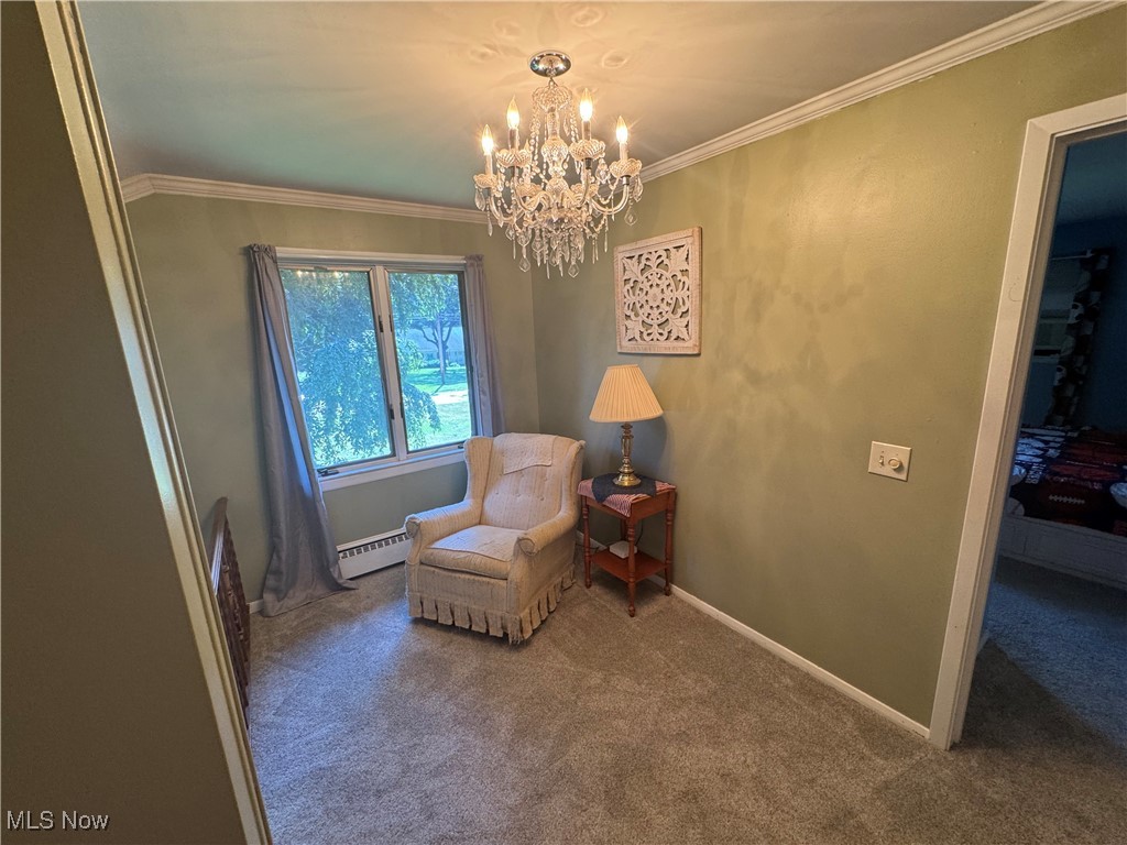 1452 Avalon Road Wooster, OH 44691 - Photo 24 of 31 Living area with a baseboard heating unit, a chandelier, carpet flooring, and crown molding