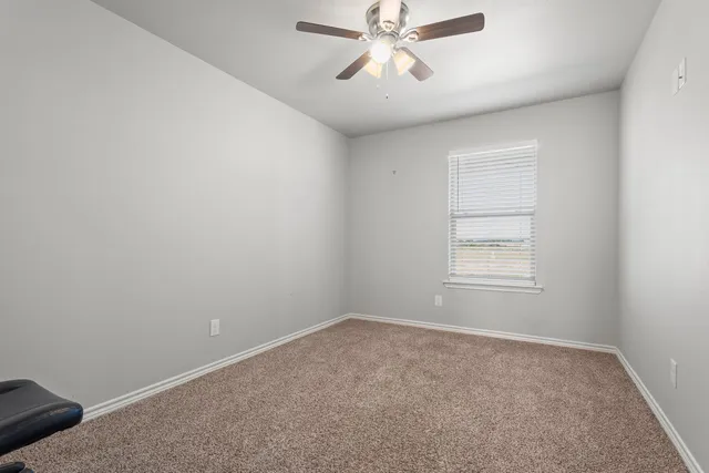 a bathroom with a granite countertop sink a toilet and a large mirror