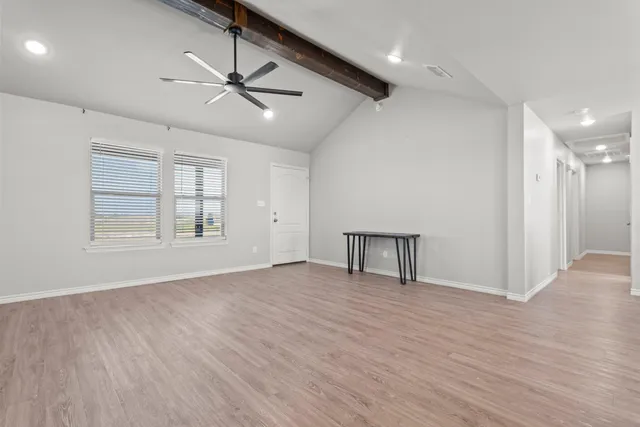 a view of work space with wooden floor and windows