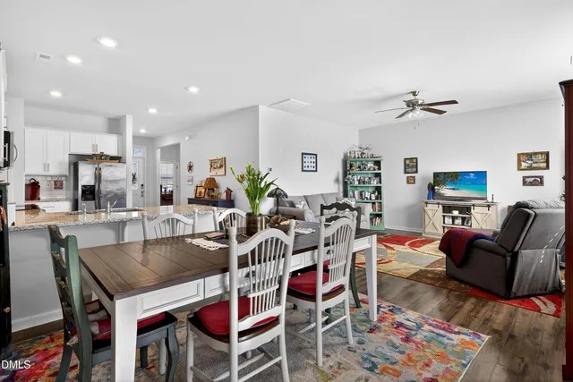 a kitchen with stainless steel appliances granite countertop a sink refrigerator and microwave