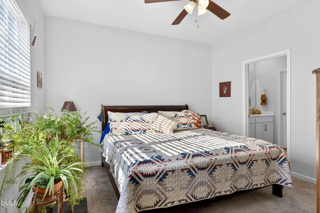 a bedroom with a bed and a mirror