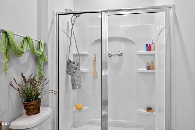 a bathroom with a shower a toilet and a shower