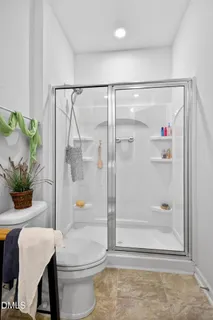 a bathroom with a sink a toilet and shower curtain