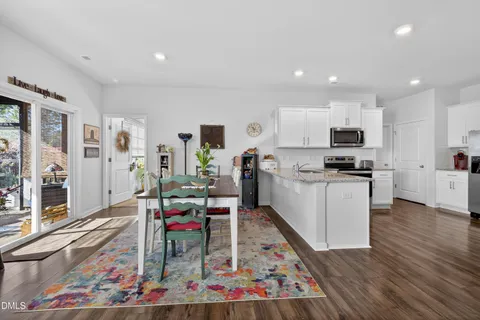 a kitchen with granite countertop a refrigerator and a stove top oven