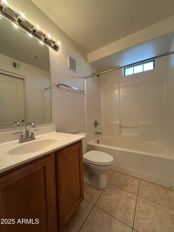 a view of a lake with lawn chairs and a big yard