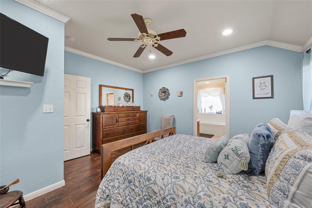 142 Phillip Circle Hewitt, TX 76643 - Photo 12 of 24 Bedroom featuring dark wood-style floors, crown molding, and a ceiling fan