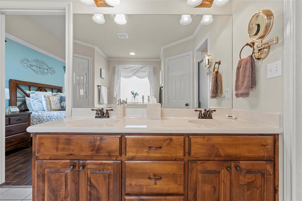 142 Phillip Circle Hewitt, TX 76643 - Photo 14 of 24 Bathroom featuring double vanity, ornamental molding, and ensuite bath