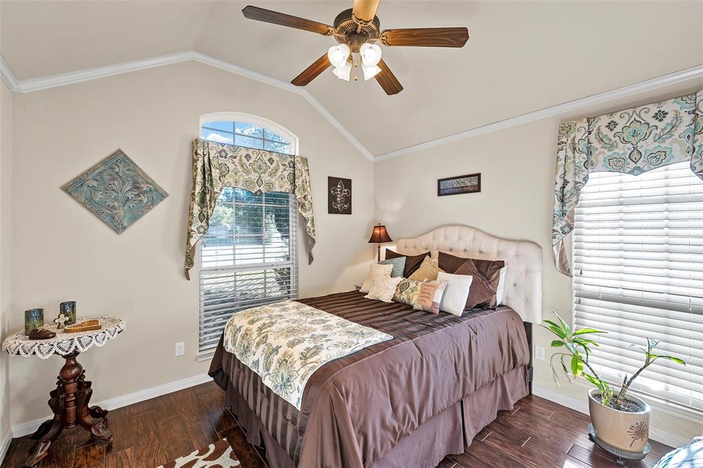 142 Phillip Circle Hewitt, TX 76643 - Photo 16 of 24 Bedroom featuring lofted ceiling, dark wood-style floors, crown molding, and a ceiling fan