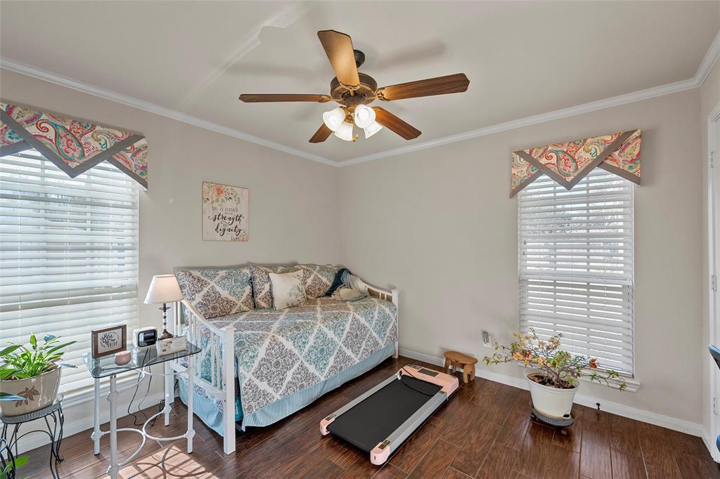 142 Phillip Circle Hewitt, TX 76643 - Photo 18 of 24 Bedroom featuring a ceiling fan, wood finished floors, and ornamental molding