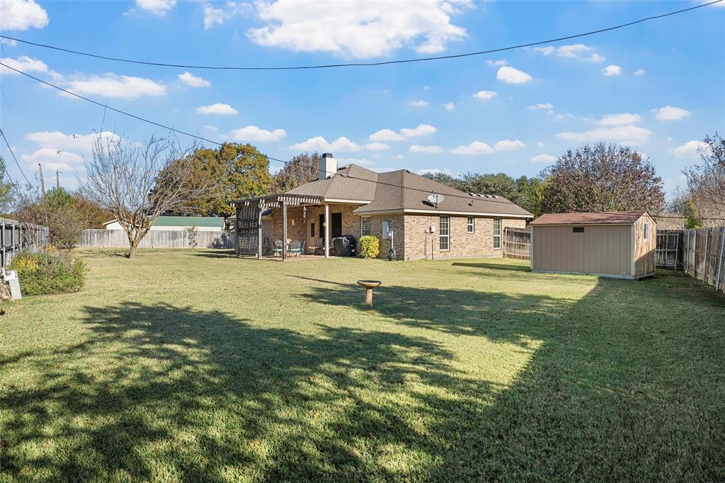 142 Phillip Circle Hewitt, TX 76643 - Photo 23 of 24 Fenced backyard with a patio area and a storage unit