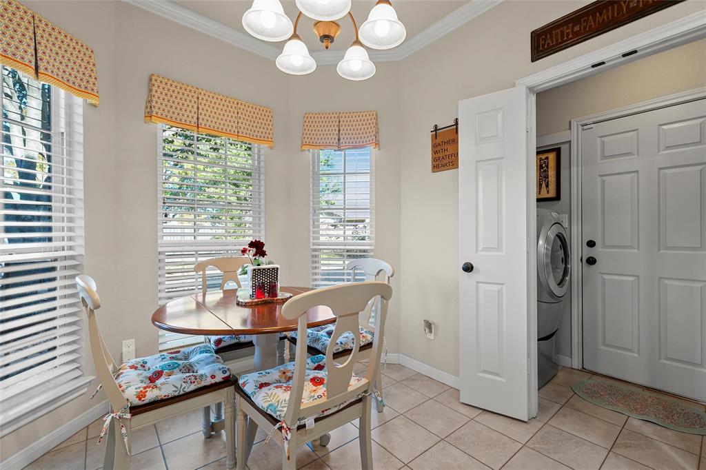 142 Phillip Circle Hewitt, TX 76643 - Photo 10 of 24 Dining room with crown molding, washer / dryer, light tile patterned floors, and a chandelier