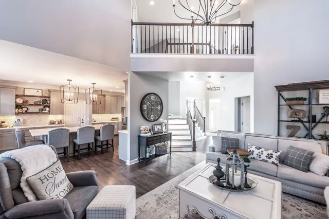 a living room with furniture a rug and a window