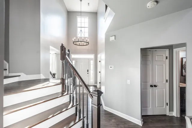 a view of entryway and hall with wooden floor