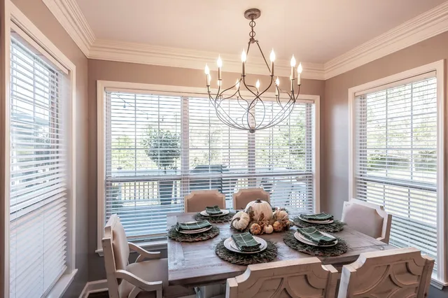 a living room with furniture and floor to ceiling windows