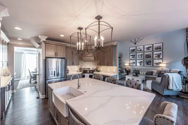 a very nice looking dining room with a large window and stainless steel appliances
