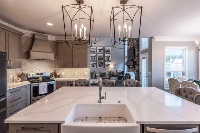a kitchen with stainless steel appliances a sink stove and cabinets