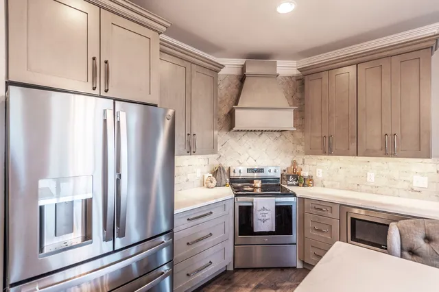 a kitchen with stainless steel appliances a refrigerator sink and cabinets