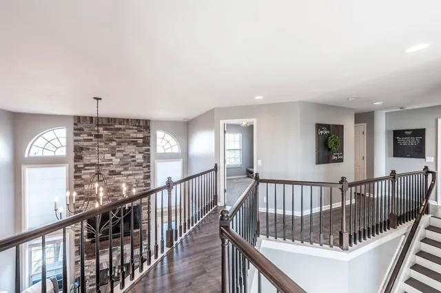 a view of staircase with railing and a window