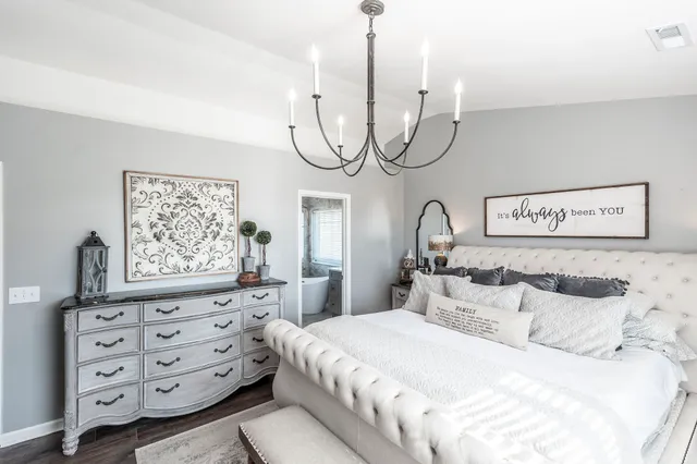 a bedroom with a bed dresser and a window