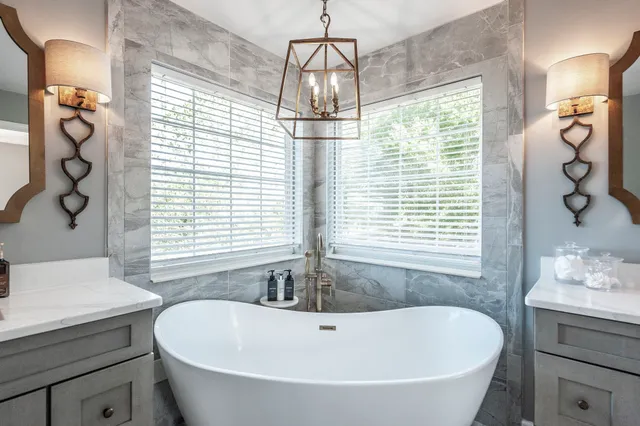 a bathroom with a bathtub a sink and a window