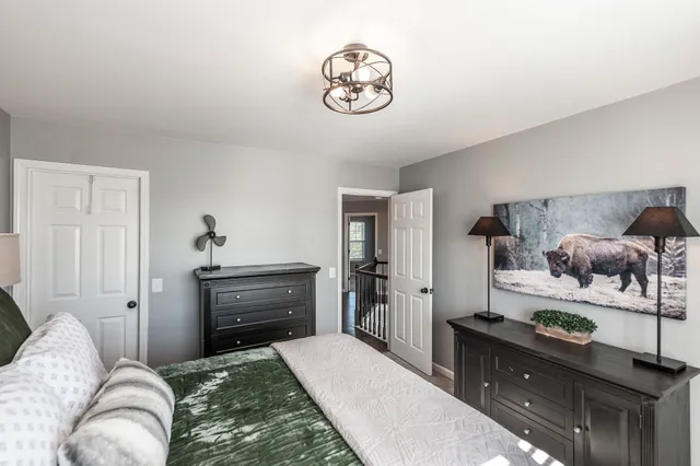 a bedroom with a bed and a chandelier