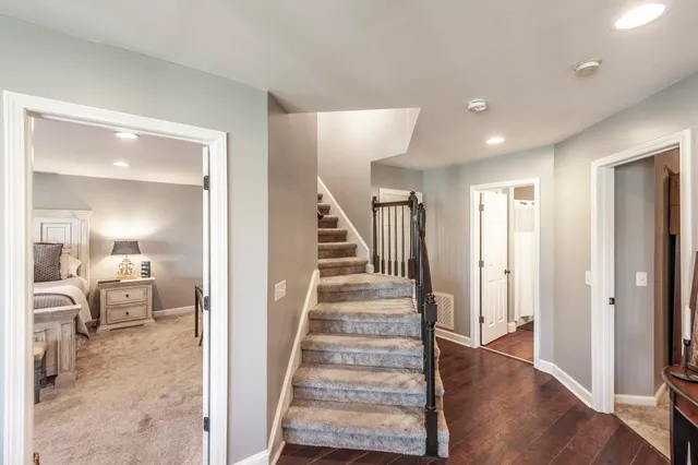 a view of a hallway with wooden floor fireplace and living room