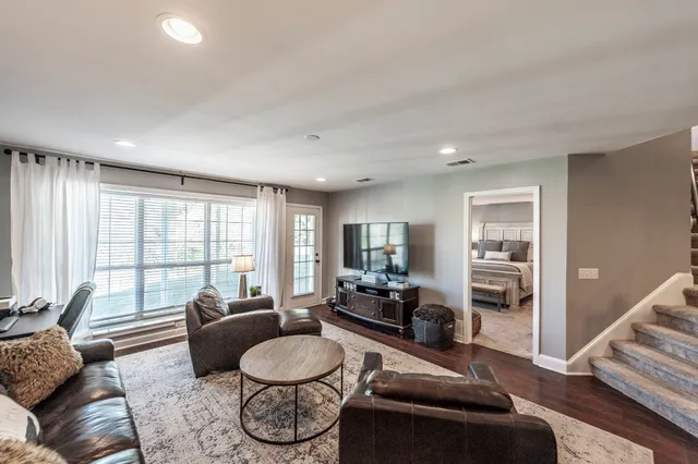 a living room with furniture and a large window