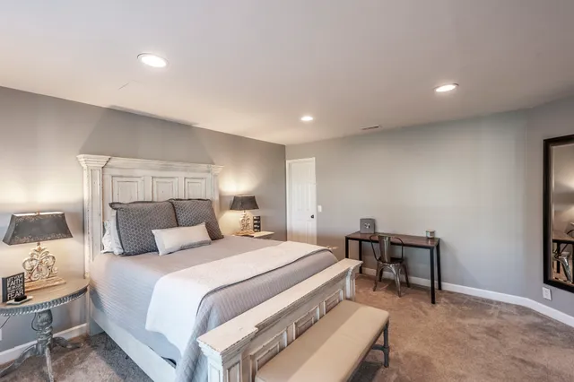 a bedroom with a bed and a lamp