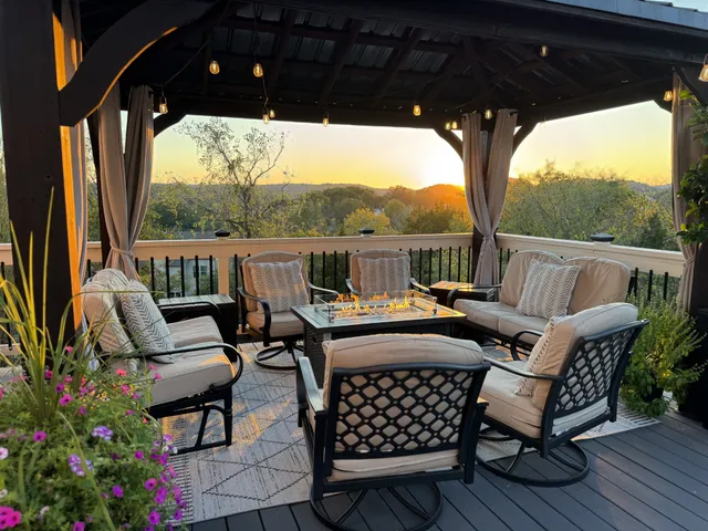 a view of a balcony with furniture and wooden floor