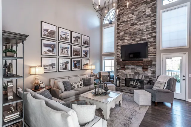 a living room with furniture a flat screen tv and a fireplace