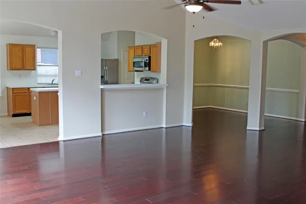 a view of a kitchen with a refrigerator a microwave and a sink
