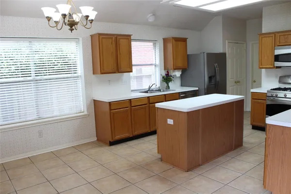 a kitchen with a cabinets counter top space and a window
