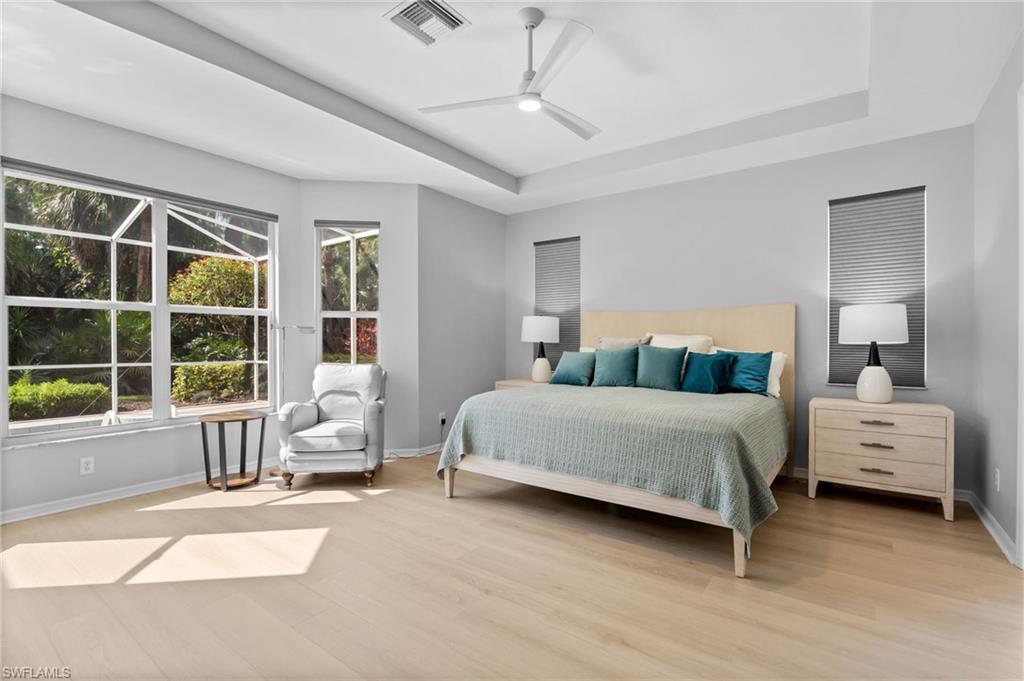 1717 Winding Oaks Way Naples, FL 34109 - Photo 14 of 29 a bedroom with a bed and a large window