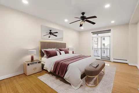 a spacious bedroom with a bed and a ceiling fan
